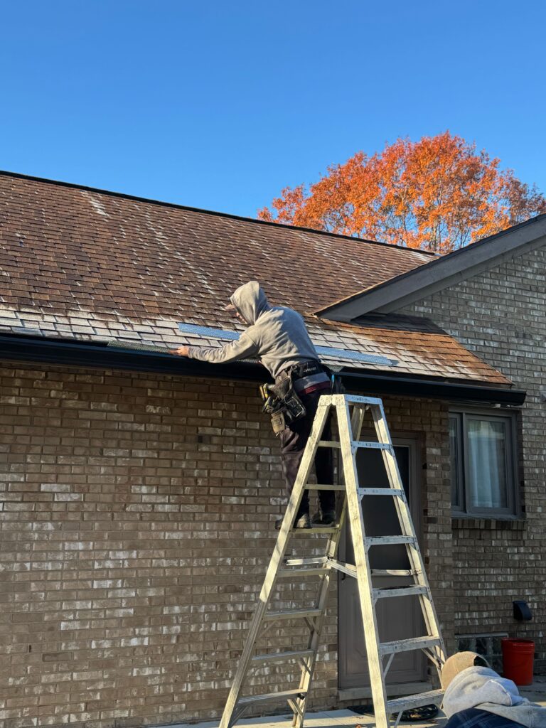 MasterCraft Coatings, LLC team fitting Seamless Gutters in Livonia, MI to improve drainage and long-term home protection.