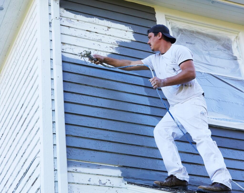 Professional painter in Milford, MI applying fresh paint to interior walls